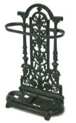 A green painted cast iron umbrella stand, with two sectional base and pierced back,