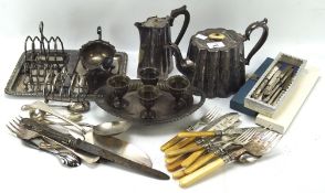 A collection of assorted silver plated wares, including toast racks, egg cups on stand,