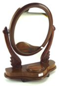 A contemporary swinging table top mirror, of oval form,