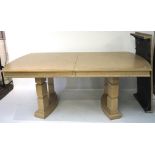 A large wooden extendable dining table, the wooden structure covered in grey veneer,