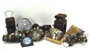 A selection of vintage bicycle lamps and car gauges,