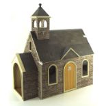 A vintage dolls house in the form of a church, with fitted interior,