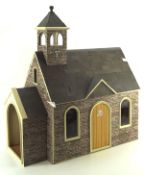 A vintage dolls house in the form of a church, with fitted interior,