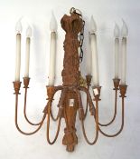A resin lied oak chandelier, with eight branches, each surmounted with an artificial candle,