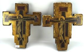 Two wooden wall hangings depicting Jesus on the cross, each with gilt decoration,