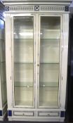 A contemporary large display cabinet, the two frontal doors with bevelled edge glass panels,