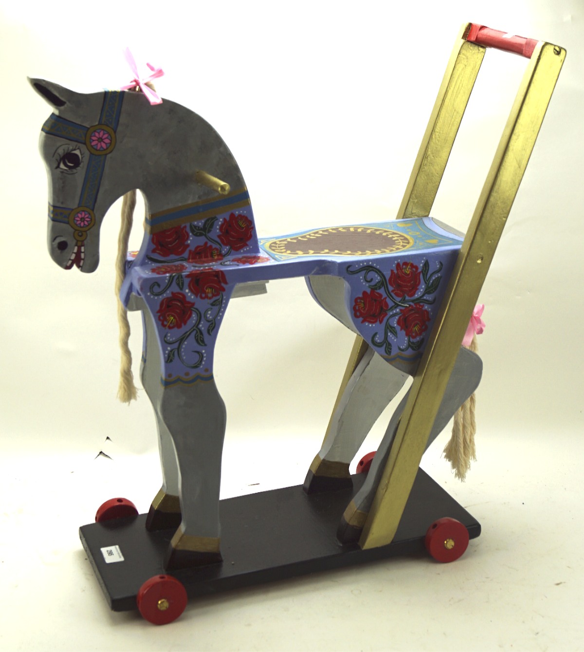 An unusual 20th century painted wooden barge ware pull-along child's dappled grey horse,