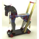 An unusual 20th century painted wooden barge ware pull-along child's dappled grey horse,