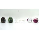 A collection of five glass paperweights, including examples by Caithness, Mdina,