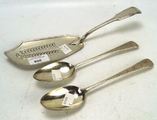 Two Georgian table spoons and a fish slice, one spoon hallmarked London 1810,