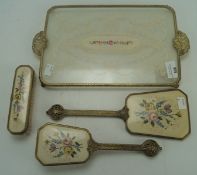 A 20th century table top four piece vanity set, including two brushes, a mirror and a tray,