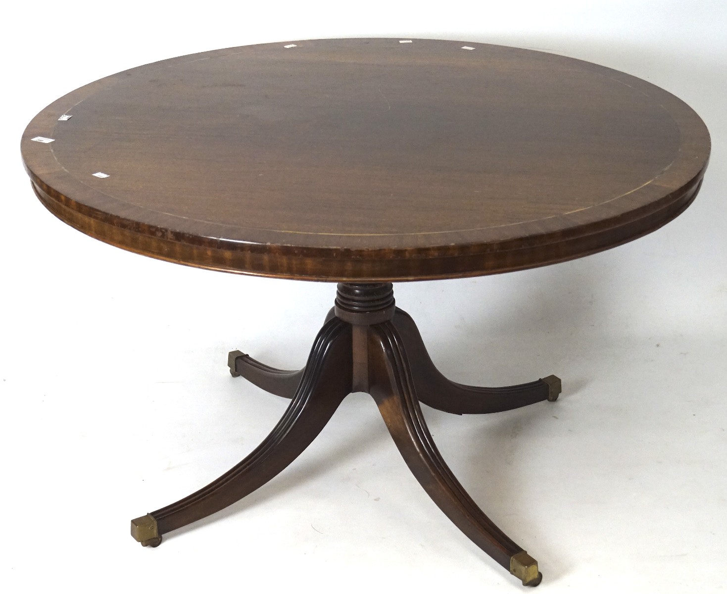 A 20th century mahogany veneer tilt top breakfast table, of circular form,