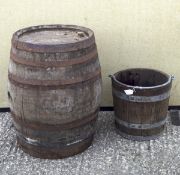 A vintage coopered wooden barrel and a similar bucket, both with metal castings,