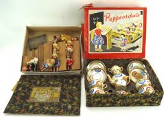 A vintage ceramic childs tea set and a selection of dolls,