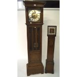 An early/mid 20th century oak cased longcase clock and a smaller grandmother clock,