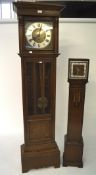 An early/mid 20th century oak cased longcase clock and a smaller grandmother clock,