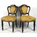 A pair of Victorian mahogany chairs, each with upholstered seat and back, in yellow,