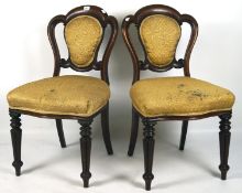 A pair of Victorian mahogany chairs, each with upholstered seat and back, in yellow,