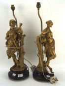 A pair of gilt spelter lamp bases, modelled as a Roman soldier and woman,