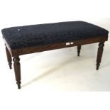 An early 20th century oak hall bench, with upholstered top, raised upon turned supports,