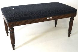 An early 20th century oak hall bench, with upholstered top, raised upon turned supports,
