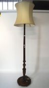 A 20th century turned mahogany standard lamp, on circular base,