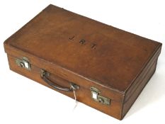 An early 20th century leather case, with fitted silk interior, monogramed 'J.R.T.
