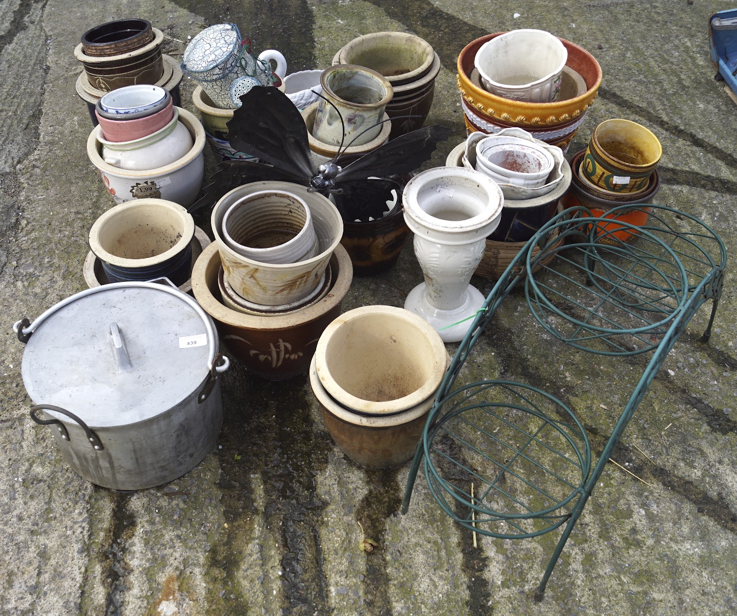 A collection of assorted plant pots, most being ceramic,