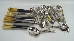 A collection of silver plated flatware, including knives, forks and spoons,
