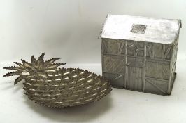 A metal biscuit tin modelled as a Tudor house and pineapple EPNS tray, height of biscuit tin 23.