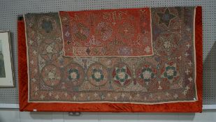 A large Mongolian wall hanging of star and foliate motifs in chain stitch on brown cotton,