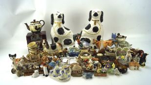 A large collection of ceramic ornaments, including Devonware, Staffordshire dogs Pendelfin,