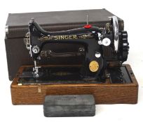 A manual Singer sewing machine, mounted on a wooden base,