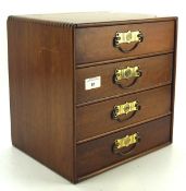 A miniature wooden chest of drawers, the four shelves of graduating size with brass handles, 30.