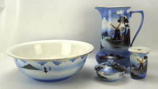 A Rubian 'Art Pottery' wash bowl and jug set, all painted with scenes of windmills on a blue ground,