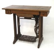 A early 20th century Singer sewing machine with treadle, the mahogany top with two drawers,