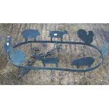 A vintage cast metal ceiling hanger, featuring the profiles of farm animals,