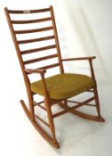 A vintage mid century rockng chair, with seven section ladder back,