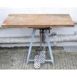 An early 20th century low work table with wooden top,