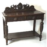 A late 19th century oak hall table, with highly carved decoration throughout,