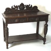 A late 19th century oak hall table, with highly carved decoration throughout,