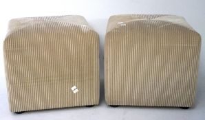 A pair of square stools, upholstered in beige reeded velvet fabric,