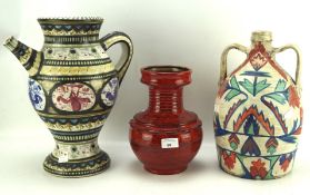 Two art pottery vases and a pouring vessel, in colourful glazes, two with handpainted decoration,