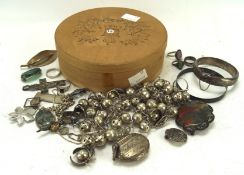 A collection of silver and white metal jewellery, including a bangle, a locket, assorted rings,