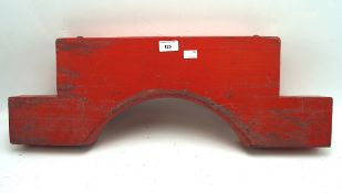 A wooden barrel holder, painted in red,