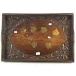 An early 20th century carved wooden butlers tray, with inlaid brass leaf motifs to the center,