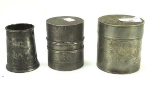 Two Chinese pewter tea caddies and a pewter cup, one tea caddy with interior lid,