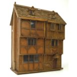 A 20th century dolls house, the wooden structure modelled as a Tudor building,