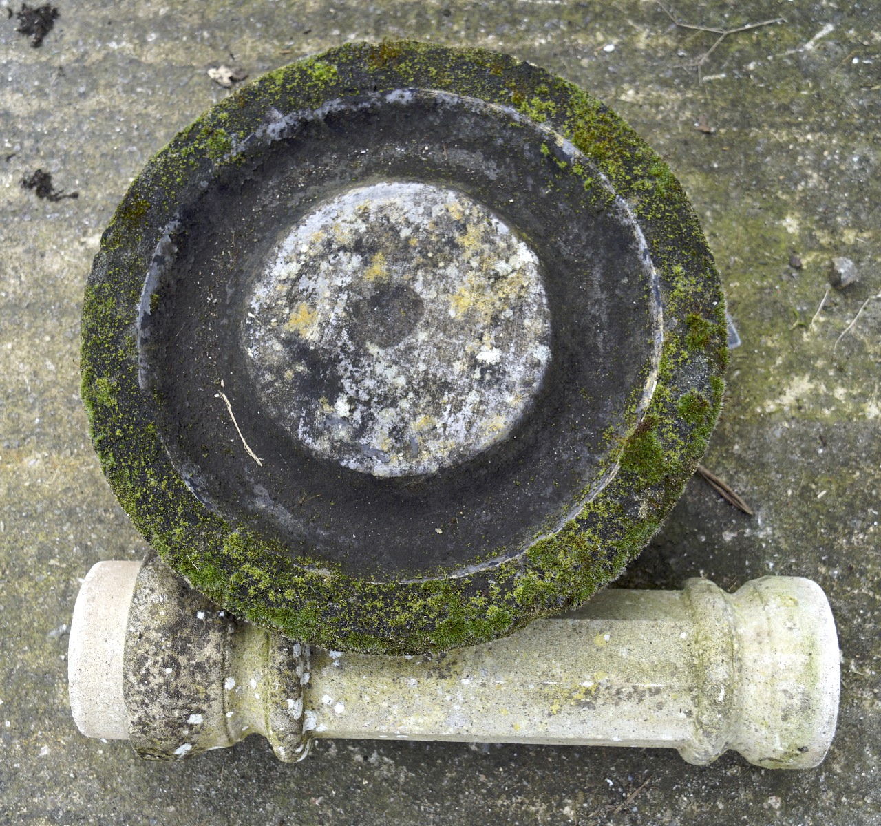 A composite stone bird bath, the pedestal moulded with brickwork,