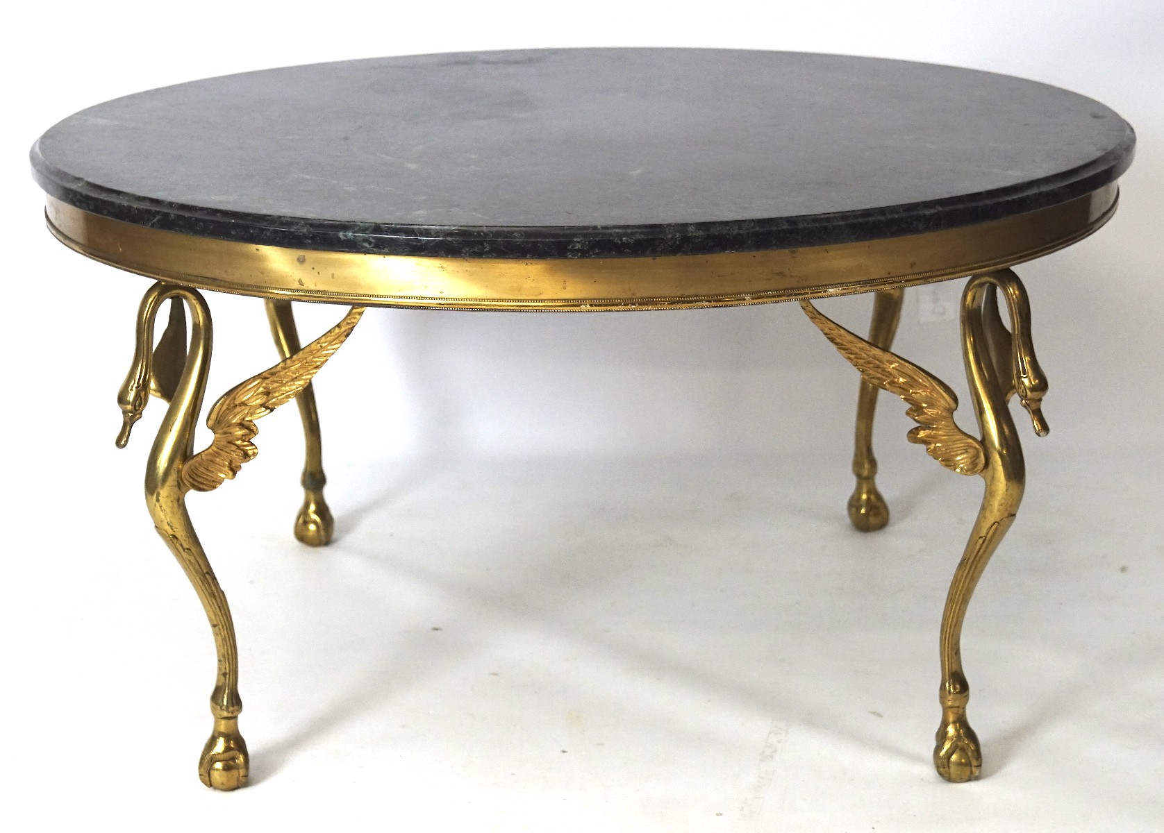 A contemporary marble topped table, of circular form, the cast brass base modelled as swans,